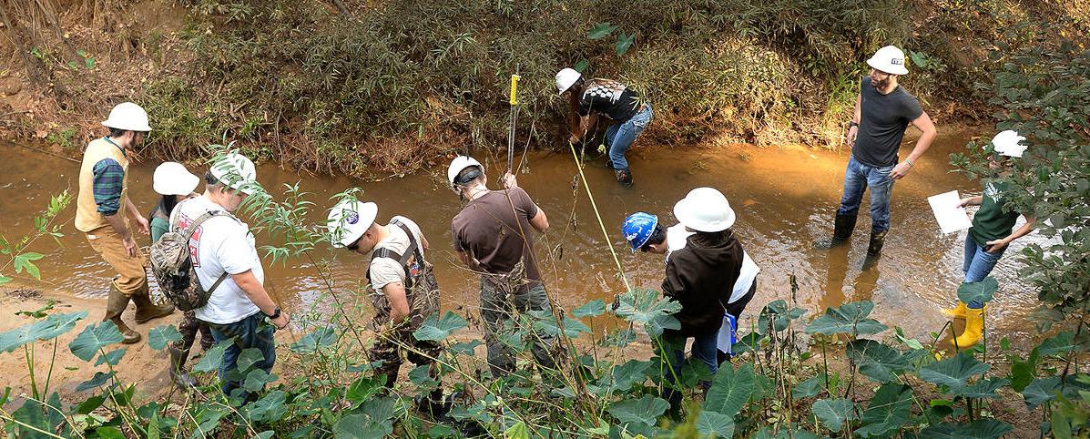 students conducting hydrology (one of our forestry programs) research in a creek